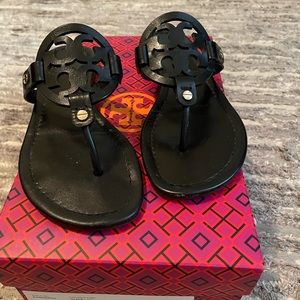 A sophisticated sandal with a foam-cushioned footbed and bold logo cutout.